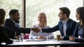 Happy multiethnic team members, conference participant, coworkers shaking hands Royalty Free Stock Photo