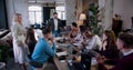 Happy multiethnic team of professional business people put hands together and clap at loft office meeting slow motion. Royalty Free Stock Photo