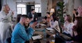 Happy multiethnic team of professional business people put hands together and clap at loft office meeting slow motion. Royalty Free Stock Photo