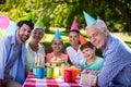 Happy multigeneration family celebrating birthday party in park
