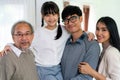 Happy multigenerational asian family portrait in living room