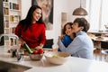 Happy multigenerational family cooking together in kitchen at home Royalty Free Stock Photo