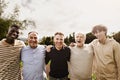 Happy multigenerational group of men with different ages and ethnicities having fun smiling in front of camera at park Royalty Free Stock Photo