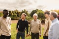 Happy multigenerational group of men with different ethnicities having fun in a public park Royalty Free Stock Photo