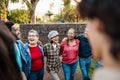 Happy multigenerational group of people with different ethnicities having fun in a public park