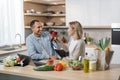 Happy multinational couple cooking dinner on the kitchen. Royalty Free Stock Photo