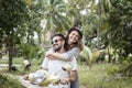 Happy multinational couple traveling on a motorbike in the jungle, honeymoon, vacation, travel concept Royalty Free Stock Photo