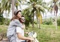 Happy multinational couple traveling on a motorbike in the jungle, honeymoon, vacation, travel concept Royalty Free Stock Photo