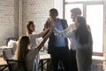 Happy multinational coworkers giving high five celebrating great teamwork result Royalty Free Stock Photo