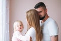 Happy multinational family father young man and mother with baby girl little daughter having fun in children room at home Royalty Free Stock Photo