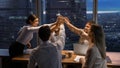 Happy multinational workers unite hands above conference desk celebrate achievement Royalty Free Stock Photo