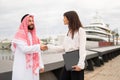 Happy multiracial business partners handshaking after successful signing contract at meeting in port Royalty Free Stock Photo