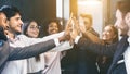 Happy multiracial business team giving high fives