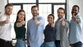 Happy multiracial businesspeople show thumbs up recommending service