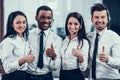 Happy multiracial call center team shows thumbs up Royalty Free Stock Photo