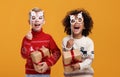 Happy multiracial children in warm knitted sweaters holding Christmas party glasses and gift boxes Royalty Free Stock Photo