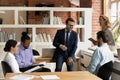 Happy multiracial colleagues have fun at office meeting Royalty Free Stock Photo