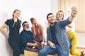 Happy mixed race colleagues taking selfie at office celebrating back to normal lifestyle Royalty Free Stock Photo