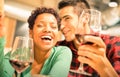 Happy multiracial couple drinking red wine at fashion bar Royalty Free Stock Photo