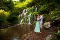 Happy multiracial couple hugging and kissing. Couple in love near waterfall in tropics. Romantic relation. Wana Amertha waterfall Royalty Free Stock Photo