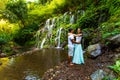 Happy multiracial couple hugging, looking to each other. Couple in love near waterfall in tropics. Romantic relation. Wana Amertha Royalty Free Stock Photo