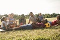 Happy multiracial families doing picnic outdoor in city park during summer vacation - Main focus child boy Royalty Free Stock Photo