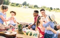 Happy multiracial families having fun with kids at picnic barbecue party - Multicultural happiness on joy and love concept Royalty Free Stock Photo