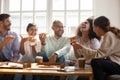 Happy multiracial friends enjoying home party time, eating pizza. Royalty Free Stock Photo