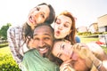 Happy multiracial friends group taking selfie sticking tongue out with funny faces - Young people sharing stories on social