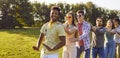 Cheerful young multiracial friends dancing in conga line at outdoor summer party in park Royalty Free Stock Photo