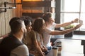 Happy multiracial friends making self-portrait during meeting in