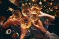 Happy multiracial friends toasting sparkling wine glasses close-up against golden bokeh lights background. Christmas