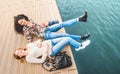Happy multiracial girlfriends having genuine fun at jetty pier d Royalty Free Stock Photo