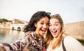 Happy multiracial girlfriends taking selfie and having fun outddors - Friendship concept with girls at spring break travel - Mode Royalty Free Stock Photo