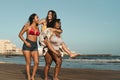 Happy multiracial girls with different body size having fun on the beach during summer holiday Royalty Free Stock Photo