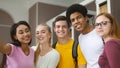 Happy multiracial young students taking selfie at library Royalty Free Stock Photo