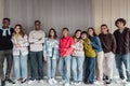 Happy multiracial group of teenagers having fun inside university