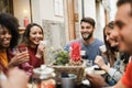 Happy multiracial having fun drinking coffee outdoor at vintage bar restaurant - Main focus on center man face Royalty Free Stock Photo