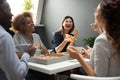 Smiling multiethnic colleagues have fun eating pizza in office Royalty Free Stock Photo