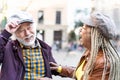 Happy multiracial senior couple having fun in city