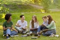 Happy multiracial students resting and preparing for exams outdoors at campus Royalty Free Stock Photo