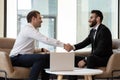 Smiling international businessmen handshake closing deal at meeting Royalty Free Stock Photo