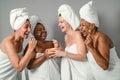 Happy multiracial women with different age and body size having skin care spa day