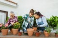 Happy multiracial women gardening at home