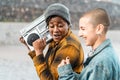 Happy multiracial women having fun dancing while listening to music with boombox stereo Royalty Free Stock Photo