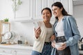 happy multiracial woman holding smartphone near Royalty Free Stock Photo