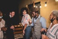 Happy multiracial young friends drinking cocktails at home party outdoors during coronavirus outbreak - Focus on african man Royalty Free Stock Photo