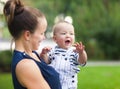 Happy mum and her child playing in park together Royalty Free Stock Photo