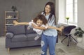 Happy mum and little daughter playing at home, having fun and enjoying good time together Royalty Free Stock Photo