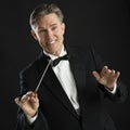 Happy Music Conductor Gesturing While Directing With His Baton
